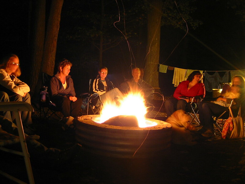 A group of happy campers around a campfire