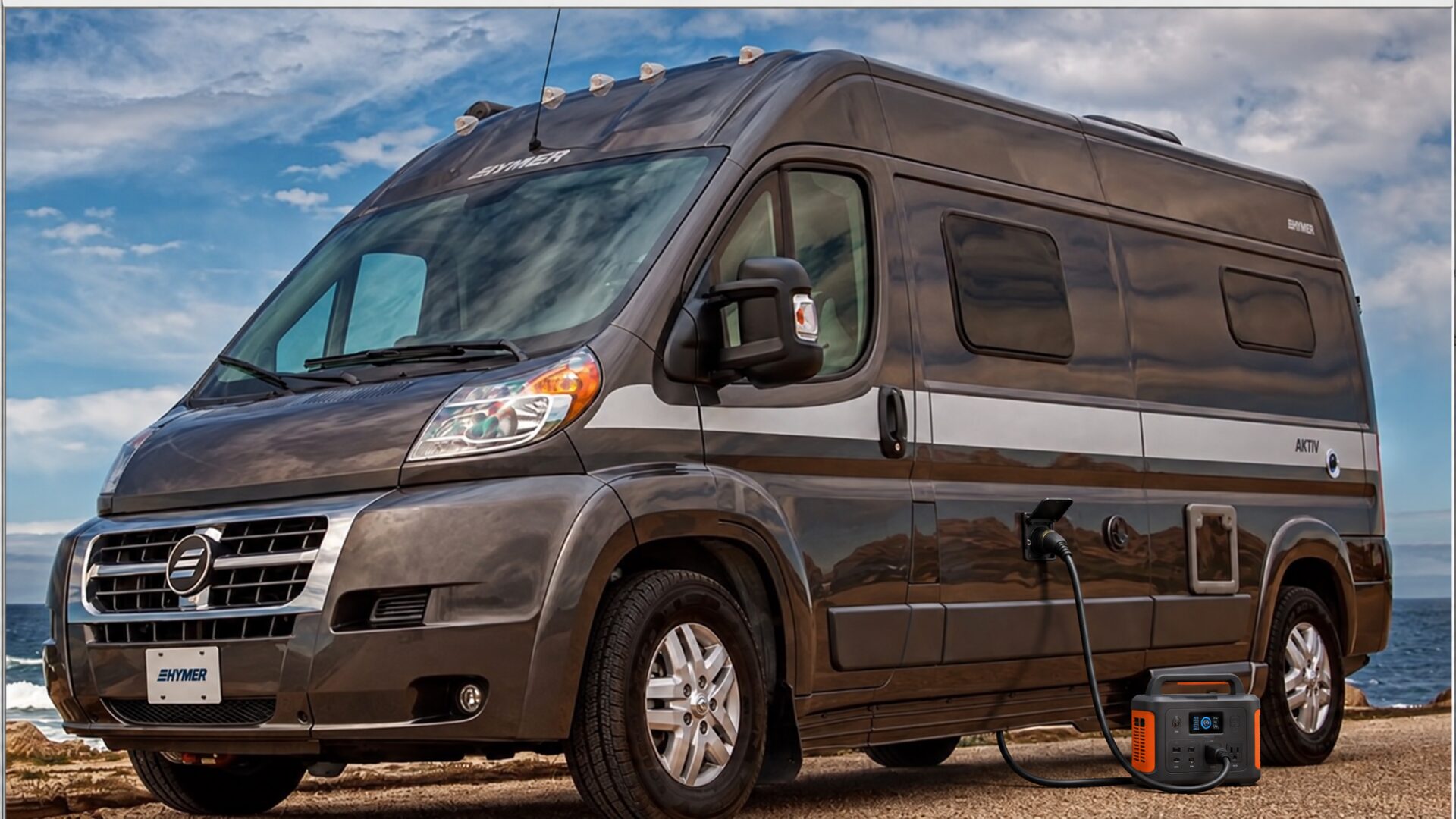 Hymer Aktiv Class B with a portable power station plugged in at a coastal campsite