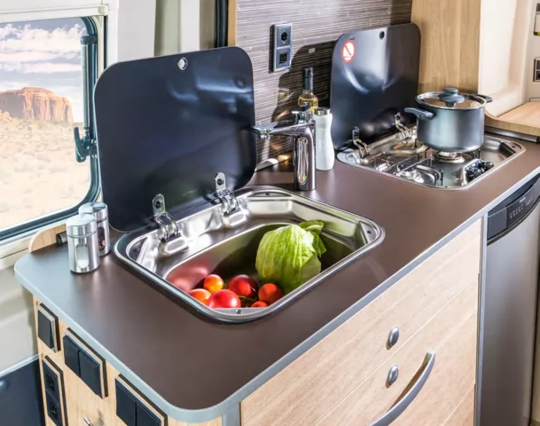 Class B camper van galley with sink and two-burner stove