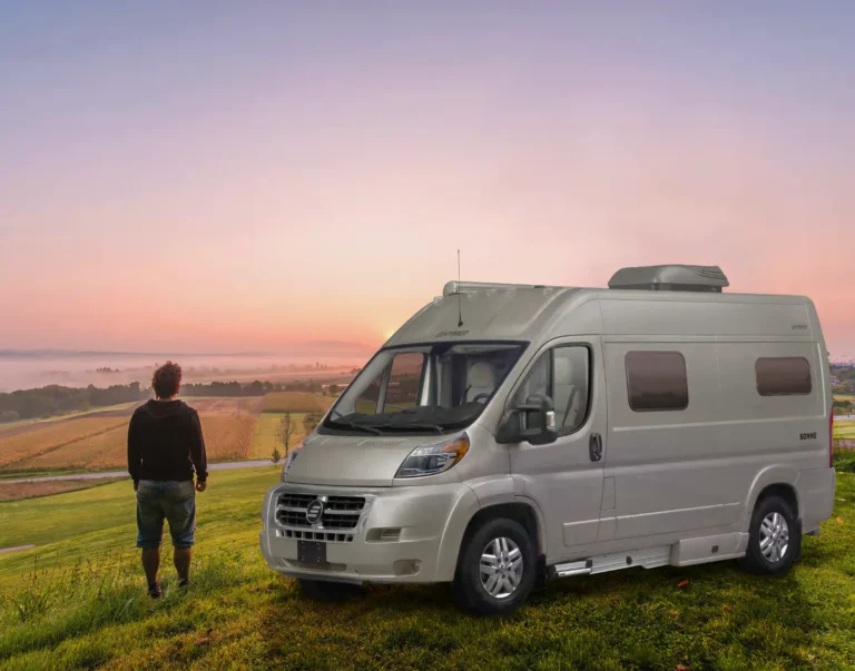 Hymer Sonne camper van parked in an open field at sunrise